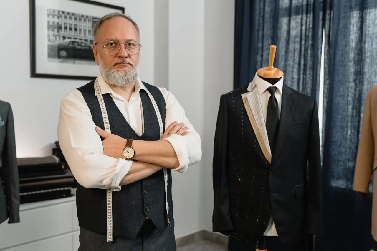 Tailor beside a suit on a mannequin